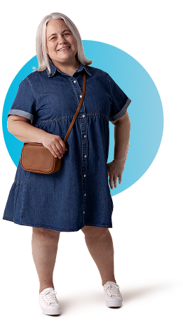 Aly, a person living with XLH, standing and smiling while holding her purse